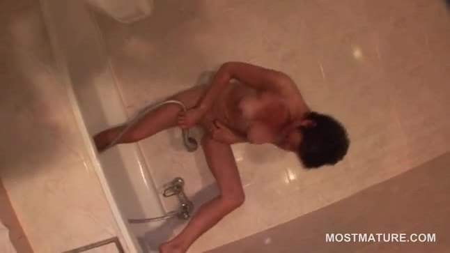 Hot mature masturbating with shower head